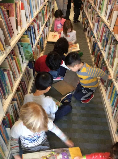 LPC preschoolers browse picture books at the public library