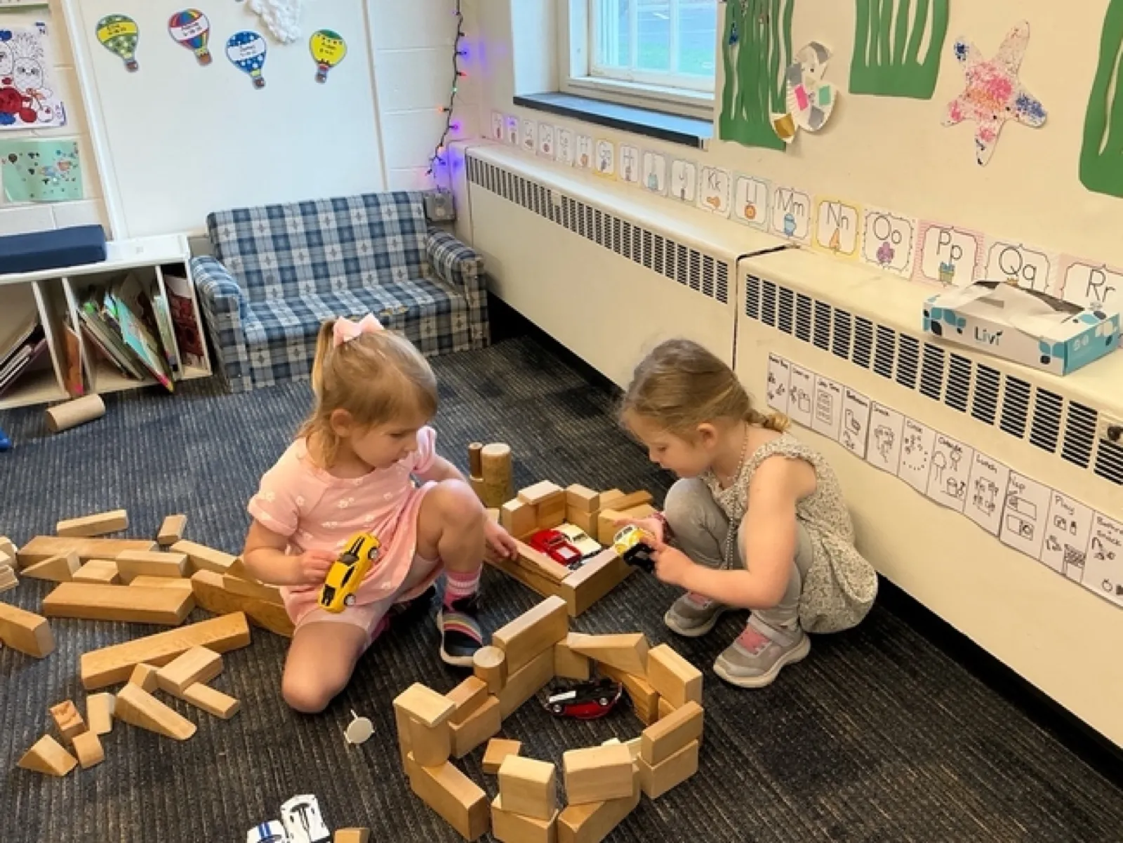 Two LPC preschoolers build a wooden-block garage for their toy cars